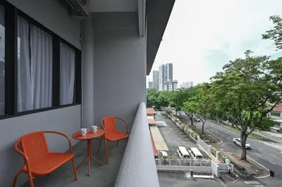 a balcony with two chairs and a table with a view at Macalister 288 in George Town