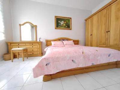 a bedroom with a bed and a dresser and a mirror at Ipoh Station 18 Homestay in Ipoh
