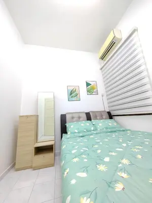 a bedroom with a bed with flowers on it at Ipoh Station 18 Homestay in Ipoh