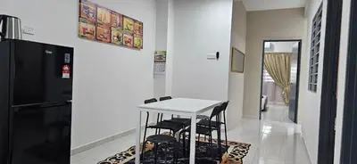 a kitchen with a white table and two black stools at Teluk Intan Homestay Landed 3BR2B in Teluk Intan
