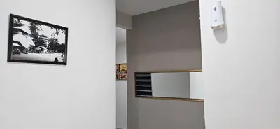 a hallway with white walls and a picture on the wall at Teluk Intan Homestay Landed 3BR2B in Teluk Intan