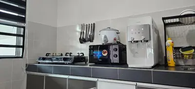 a kitchen with a counter top with a coffee maker at Teluk Intan Homestay Landed 3BR2B in Teluk Intan