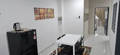 a kitchen with a black refrigerator and a table at Teluk Intan Homestay Landed 3BR2B in Teluk Intan