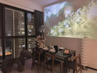 a dining room with a table and a large screen at DD Condominium 2Bedroom Sea view Georgetown Penang in Jelutong