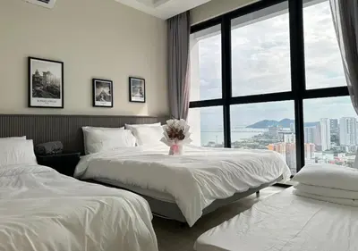 a hotel room with two beds and a large window at DD Condominium 2Bedroom Sea view Georgetown Penang in Jelutong