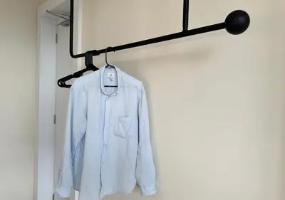 a white shirt hanging on a coat rack at DD Condominium 2Bedroom Sea view Georgetown Penang in Jelutong