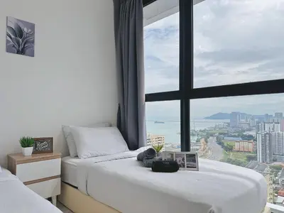 a bedroom with two beds and a large window at DD Condominium 2Bedroom Sea view Georgetown Penang in Jelutong