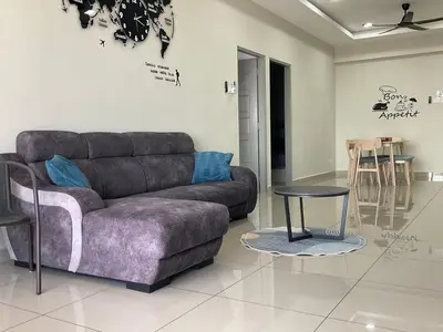 a living room with a couch and a table at Sweet Homestay 1 The Venus Sitiawan in Sitiawan