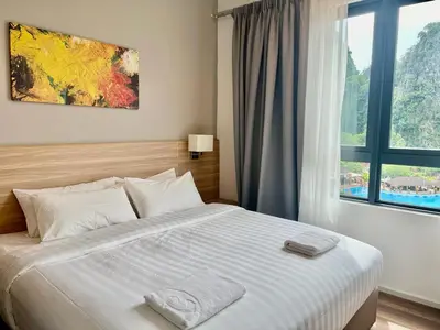 a bedroom with a large bed with a window at Hotspring 2 Room Suite @ Sunway Onsen with Theme Park View 4 to 6 pax in Tambun