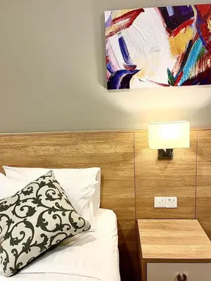 a bedroom with a bed and a painting on the wall at Hotspring 2 Room Suite @ Sunway Onsen with Theme Park View 4 to 6 pax in Tambun