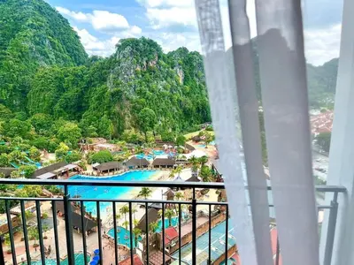 a view from a balcony of a resort with a pool at Hotspring 2 Room Suite @ Sunway Onsen with Theme Park View 4 to 6 pax in Tambun