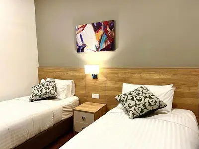 a hotel room with two beds and a lamp at Hotspring 2 Room Suite @ Sunway Onsen with Theme Park View 4 to 6 pax in Tambun