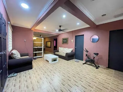 a living room with a couch and a bike in it at MP Homestay Lost world of tambun in Kampong Batu Lapan