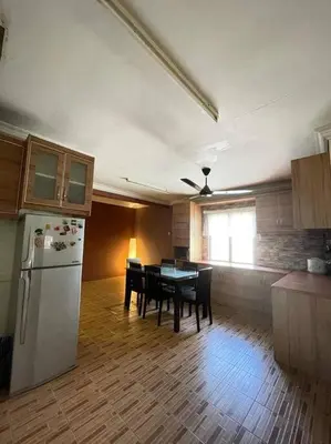 a kitchen with a refrigerator and a table in it at MP Homestay Lost world of tambun in Kampong Batu Lapan