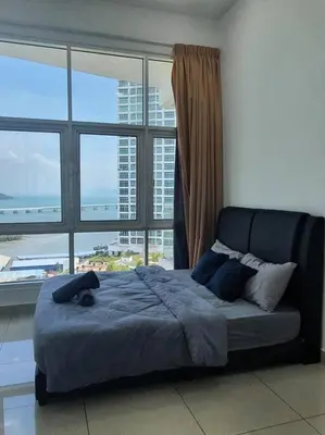 a bed in a room with a large window at Southbay Seaview Condo A16 #10minQueensbay #15minSPICE in Bayan Lepas