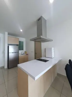 a kitchen with a white counter top and a refrigerator at Southbay Seaview Condo A16 #10minQueensbay #15minSPICE in Bayan Lepas