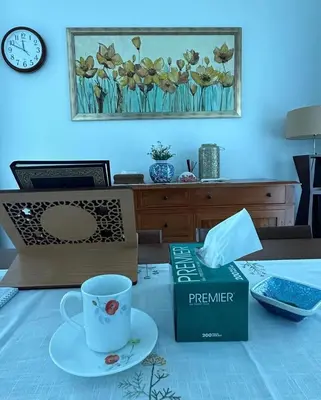 a table with a book and a coffee cup on it at Tiny House PT82 Kg Gumut Tambahan in Kalumpang
