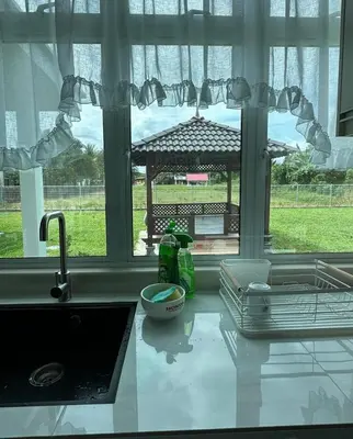 a kitchen counter with a sink and a window at Tiny House PT82 Kg Gumut Tambahan in Kalumpang