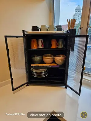 an open refrigerator with bowls and plates in it at Lumina Stay @ Kampar 16 pax in Kampar