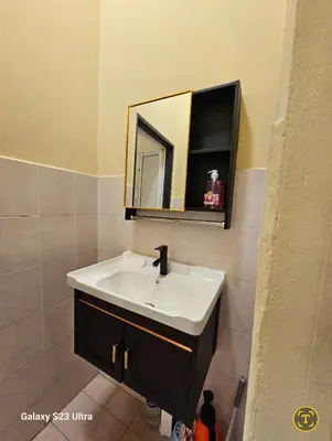 a bathroom with a white sink and a mirror at Lumina Stay @ Kampar 16 pax in Kampar
