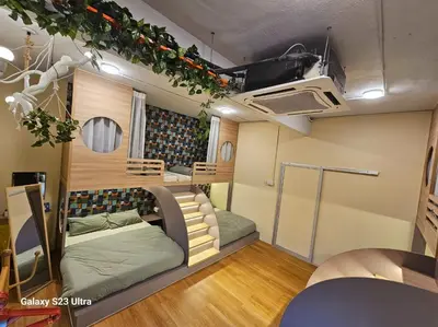 a room with two beds in a tiny house at Lumina Stay @ Kampar 16 pax in Kampar