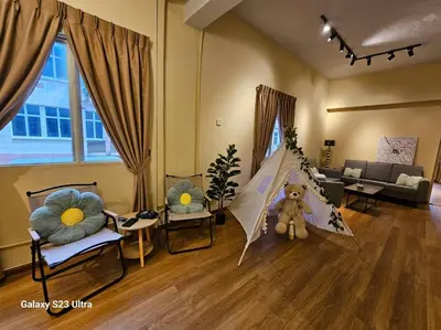 a living room with a teddy bear in a room at Lumina Stay @ Kampar 16 pax in Kampar