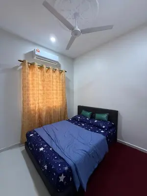 a bedroom with a bed and a ceiling fan at Homestay Desa D Junjung Islam Guest Only in Simpang Ampat