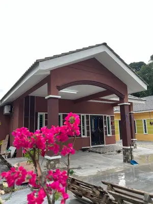 a building with pink flowers in front of it at Homestay Desa D Junjung Islam Guest Only in Simpang Ampat