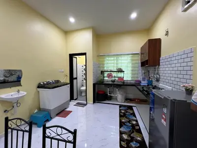 a kitchen with a counter and a sink and a refrigerator at Homestay Desa D Junjung Islam Guest Only in Simpang Ampat