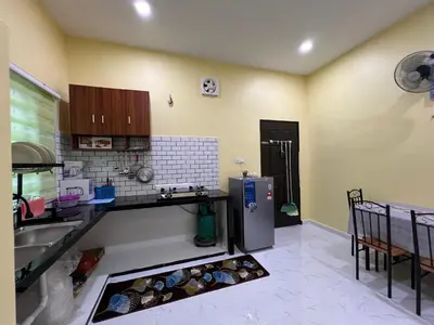 a kitchen with a sink and a refrigerator at Homestay Desa D Junjung Islam Guest Only in Simpang Ampat