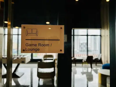a sign that says game room and lounge at New 2BR or 3BR Homey Getaway stay 7 to 10 pax at Urban Suites, Georgetown by URBAN STAYCATION LOD COSY in Jelutong