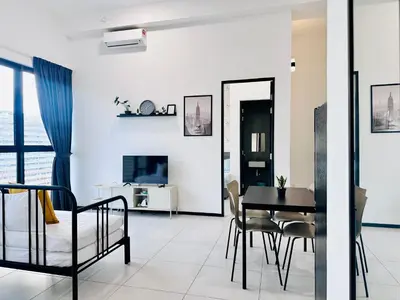 a dining room and living room with a table and chairs at New 2BR or 3BR Homey Getaway stay 7 to 10 pax at Urban Suites, Georgetown by URBAN STAYCATION LOD COSY in Jelutong