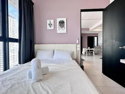 a bedroom with a large white bed with purple walls at New 2BR OR 3BR Cityview Homestay at Urban Suite BY URBAN STAYCATION LDL in Jelutong