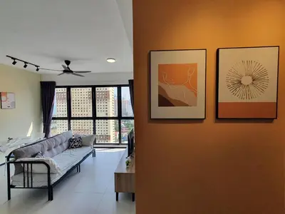 a living room with a couch and paintings on a wall at Urban Suite Spacious 2 or 3 Bedroom and 2Bathroom at Georgetown by URBAN STAYCATION HENG COSY in Jelutong