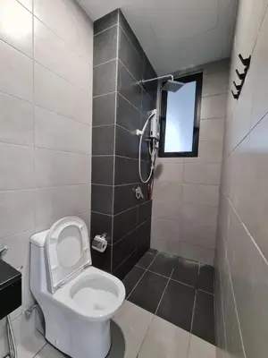 a bathroom with a toilet and a shower with a window at Urban Suite Spacious 2 or 3 Bedroom and 2Bathroom at Georgetown by URBAN STAYCATION HENG COSY in Jelutong
