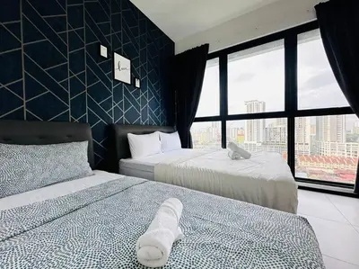 a hotel room with two beds and a window at Urban Suite Spacious 2 or 3 Bedroom and 2Bathroom at Georgetown by URBAN STAYCATION HENG COSY in Jelutong