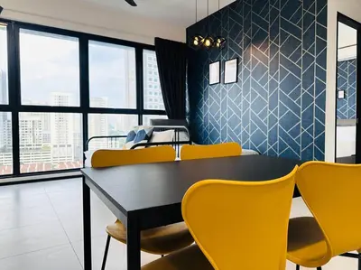 a dining room with a black table and yellow chairs at Urban Suite Spacious 2 or 3 Bedroom and 2Bathroom at Georgetown by URBAN STAYCATION HENG COSY in Jelutong