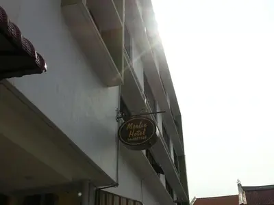 a sign for a hotel on the side of a building at Merlin Hotel George Town Penang in George Town