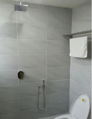 a bathroom with a toilet and a shower at Merlin Hotel George Town Penang in George Town