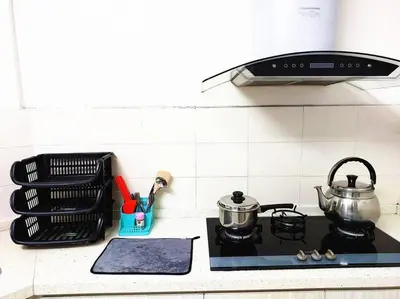 a stove top with a pot and a tea kettle at TuR15 PisaStadium 9pax 4rooms PrivateHouse in Bayan Lepas