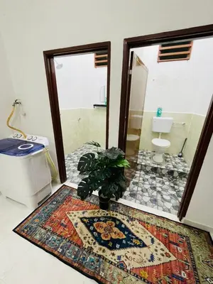 a bathroom with a toilet and a rug on the floor at Tok Mak Homestay Bukit Mertajam in Kubang Semang