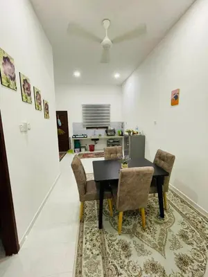 a dining room with a black table and chairs at Tok Mak Homestay Bukit Mertajam in Kubang Semang