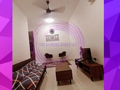a living room with a couch and a table at The Clemira Homestay @ Sungai Karangan, Kulim, Kedah in Padang Serai
