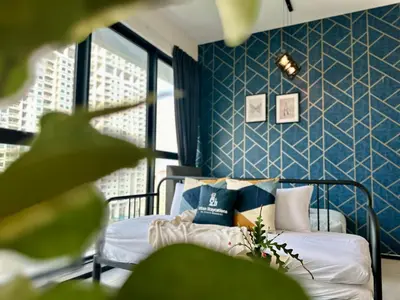a bedroom with a bed with blue walls at Cozy & Drive Urban Suite by WL in Jelutong