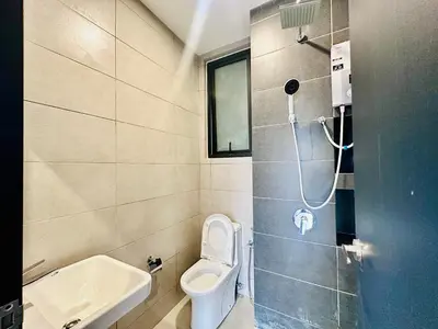 a small bathroom with a toilet and a sink at Cozy & Drive Urban Suite by WL in Jelutong
