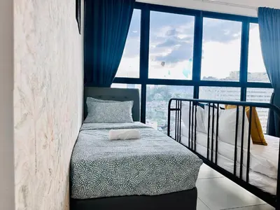 a bedroom with a bed and a large window at Cozy & Drive Urban Suite by WL in Jelutong