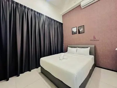 a bedroom with a large bed with black curtains at Cozy & Drive Urban Suite by WL in Jelutong