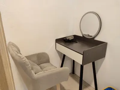 a mirror sitting on a desk next to a chair at Golden 78 Ipoh Homestay in Ipoh