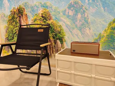 a black chair next to a table with a laptop on it at Golden 78 Ipoh Homestay in Ipoh