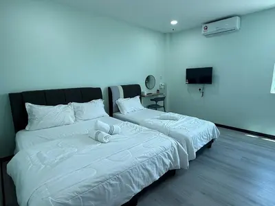 two beds sitting next to each other in a room at Good Night BD Motel -PEKAN BAGAN DATUK-SELF CHECK IN in Bagan Datuk